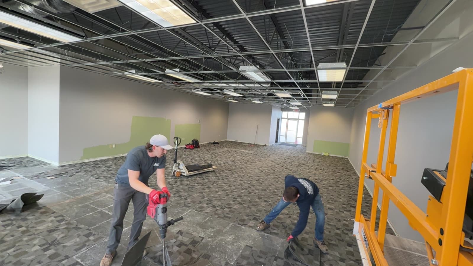 Commercial remodel — crew installing tile and framing on site